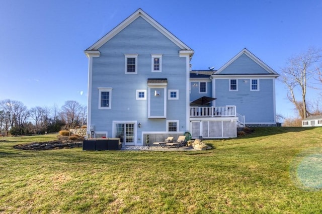 back of property with a patio and a yard