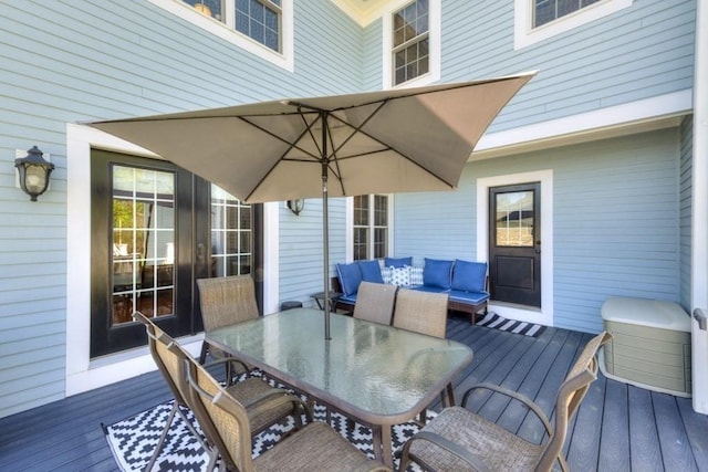 wooden terrace with outdoor dining area and outdoor lounge area