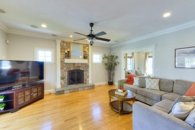 living room with ceiling fan, ornamental molding, and wood finished floors