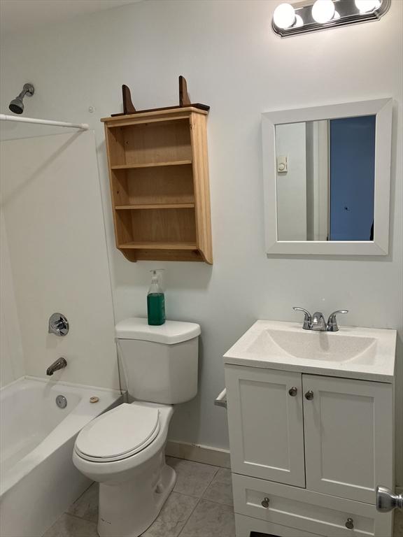 383 Revere Beach Blvd Unit 5, Revere, MA 02156 - full bathroom with toilet, shower / bath combination, vanity, tile patterned floors, and baseboards