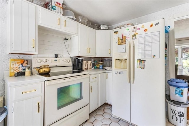 440 Broadway, North Attleboro, MA 02760 - kitchen with white appliances, light countertops, tasteful backsplash, white cabinets, and light tile patterned flooring