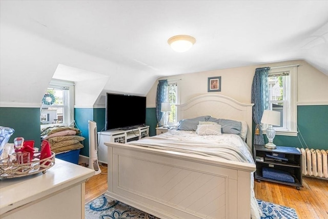 440 Broadway, North Attleboro, MA 02760 - bedroom featuring radiator, vaulted ceiling, multiple windows, and light wood-style flooring