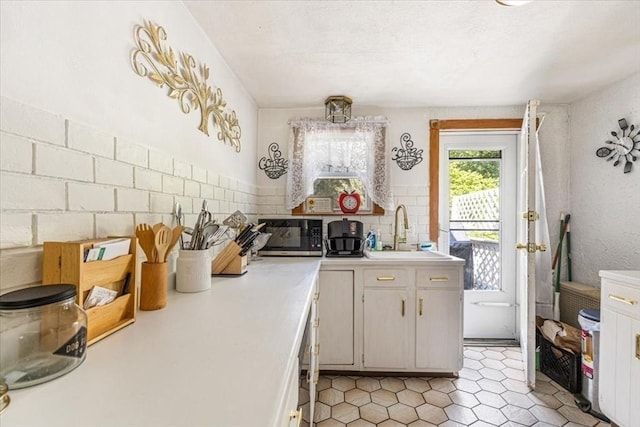 440 Broadway, North Attleboro, MA 02760 - kitchen featuring stainless steel microwave, light countertops, decorative backsplash, and light tile patterned floors