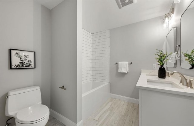 full bathroom featuring vanity, toilet, and tiled shower / bath