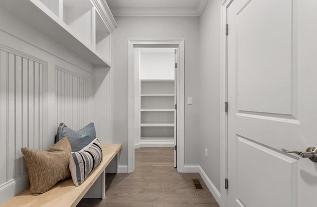 mudroom with crown molding and light hardwood / wood-style flooring