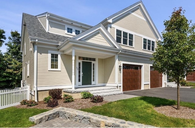 view of front of home featuring covered porch and a garage