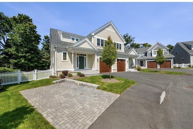 view of front of property with a front yard and a garage