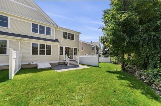 rear view of property with a yard