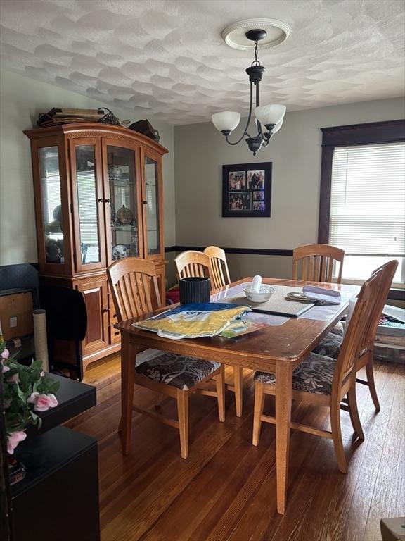 20 Osgood Ave, Lowell, MA 01850 - dining area with wood-type flooring and a chandelier