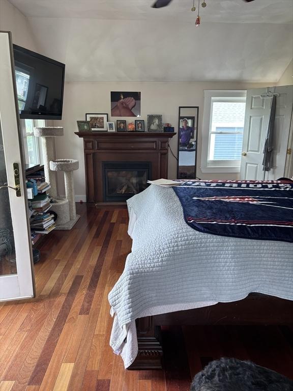 20 Osgood Ave, Lowell, MA 01850 - bedroom with a glass covered fireplace and wood finished floors