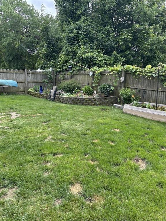 20 Osgood Ave, Lowell, MA 01850 - fenced backyard featuring a garden