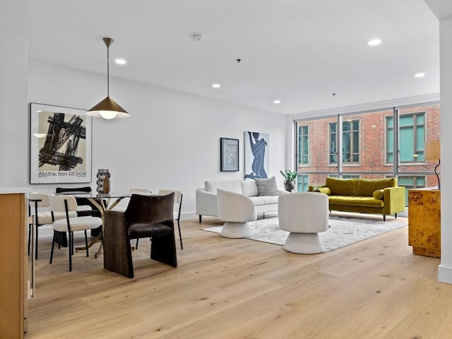 living area with recessed lighting and light wood-style flooring