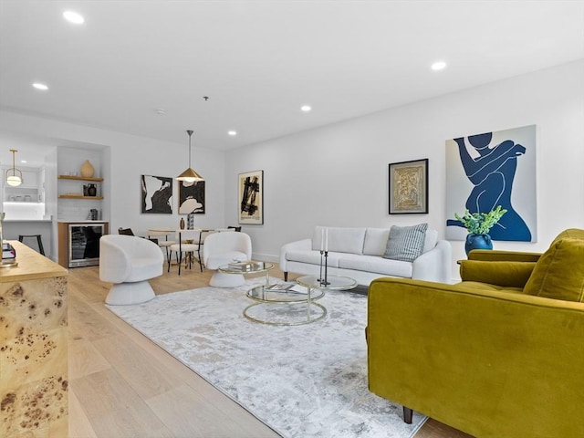 living room featuring beverage cooler, recessed lighting, and wood finished floors