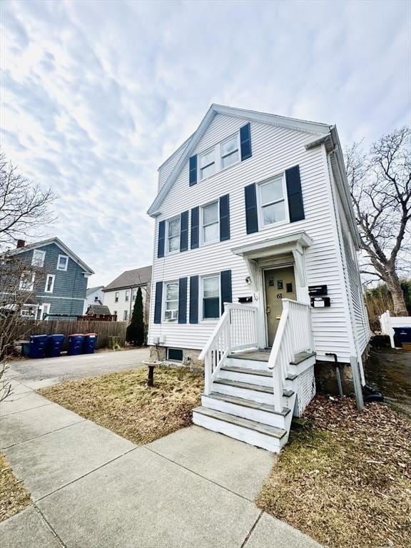 view of front of house featuring driveway and fence