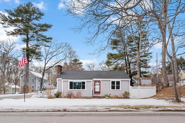 ranch-style house featuring fence and a chimney