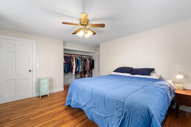 bedroom with a ceiling fan, a closet, baseboards, and wood finished floors