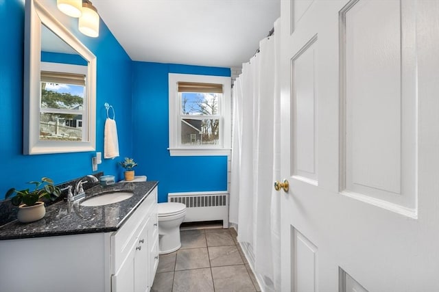 full bath with radiator, tile patterned flooring, toilet, and vanity