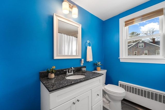 full bathroom with radiator, vanity, and toilet