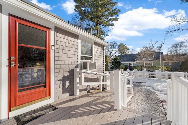 wooden terrace featuring cooling unit and fence