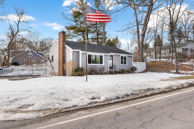 view of front of house featuring a chimney and fence