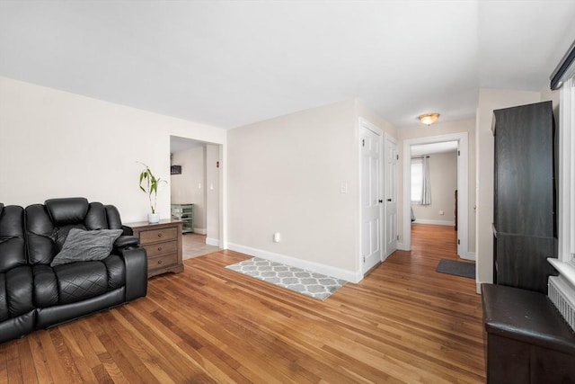 living room featuring light wood-style floors and baseboards