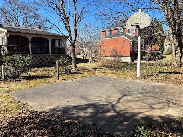 exterior space featuring driveway and a sunroom