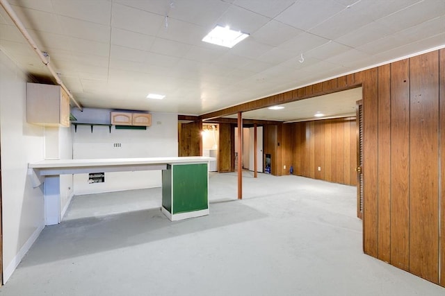 finished basement featuring wooden walls