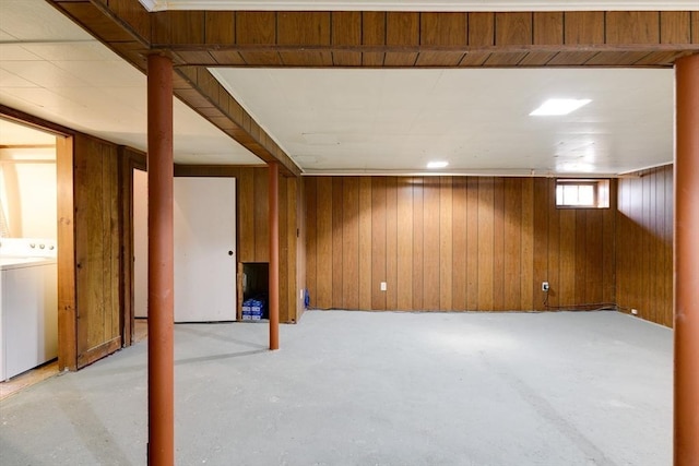 basement with washer / dryer and wood walls