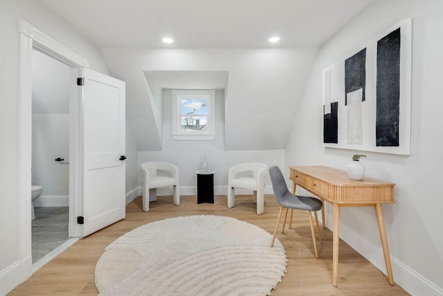 bathroom with hardwood / wood-style flooring, toilet, and lofted ceiling