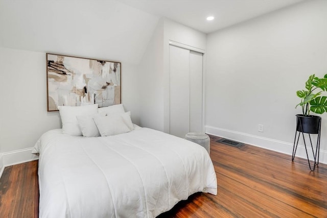 bedroom featuring dark hardwood / wood-style flooring and a closet