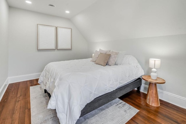 bedroom featuring dark hardwood / wood-style flooring and lofted ceiling