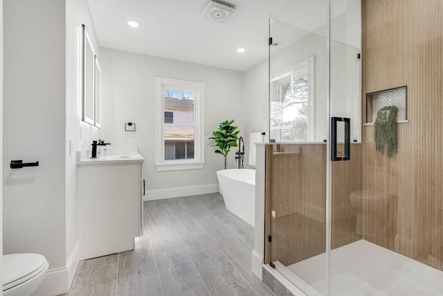 full bathroom with vanity, separate shower and tub, and toilet