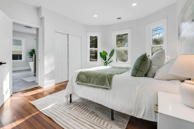 bedroom with wood-type flooring and a closet