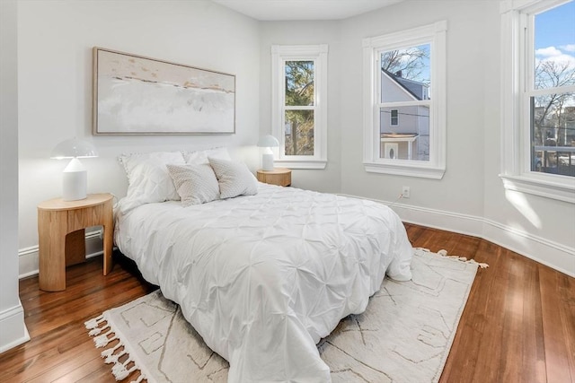 bedroom featuring hardwood / wood-style floors and multiple windows