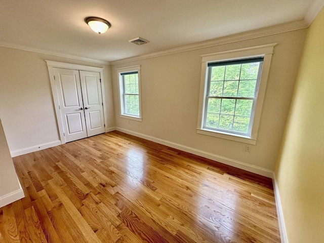 14 Pine Knoll Rd, Lexington, MA 02420 - unfurnished bedroom featuring light wood-style floors, baseboards, crown molding, and a closet