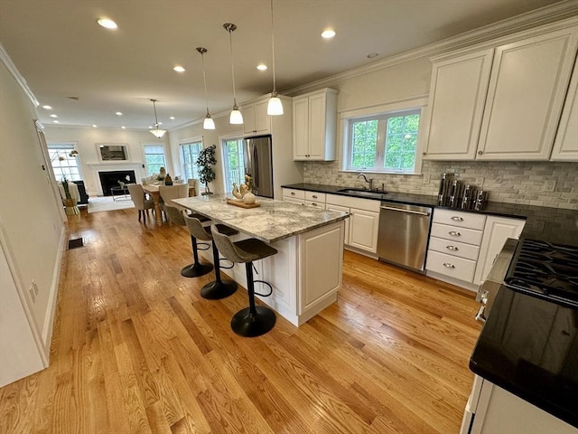 14 Pine Knoll Rd, Lexington, MA 02420 - kitchen featuring stainless steel appliances, a sink, white cabinets, open floor plan, and decorative backsplash