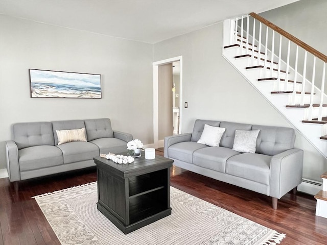 living room with baseboards, wood finished floors, baseboard heating, and stairs