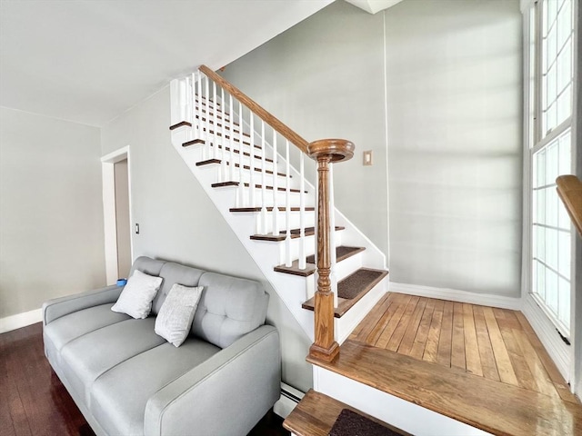 staircase with baseboards and hardwood / wood-style floors