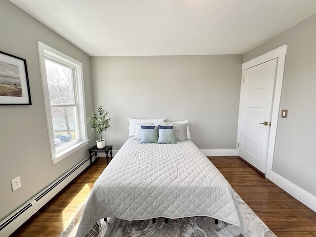 bedroom with dark wood finished floors, baseboards, and a baseboard radiator