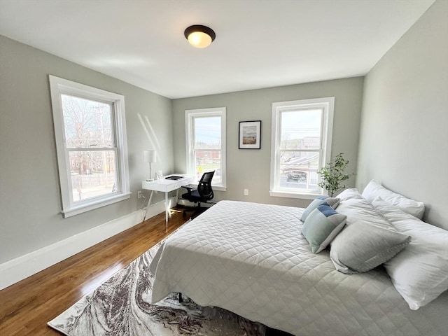 bedroom with wood finished floors and baseboards