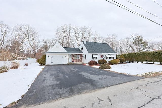 view of front of home with a garage and aphalt driveway