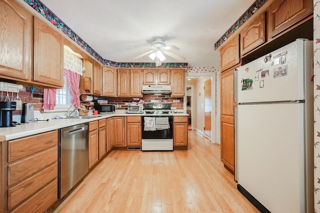 kitchen with range with electric stovetop, light countertops, freestanding refrigerator, dishwasher, and under cabinet range hood