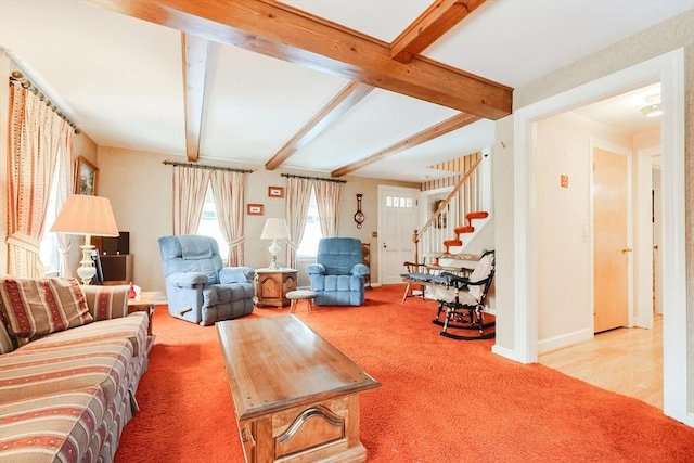 living room featuring stairs, carpet floors, beamed ceiling, and baseboards