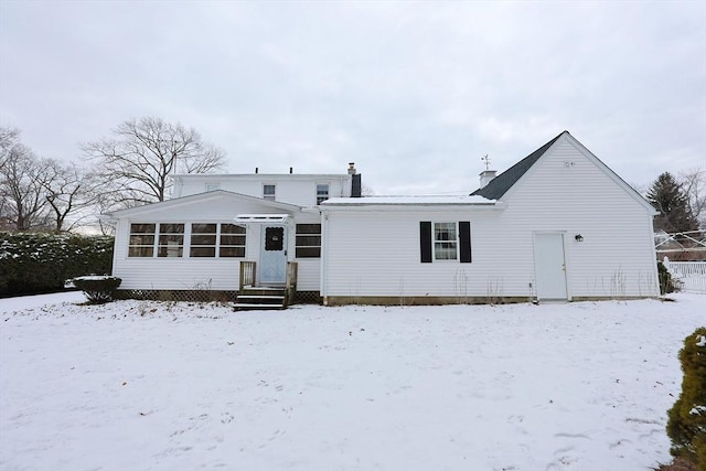 view of snow covered back of property