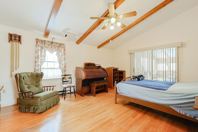 bedroom featuring lofted ceiling with beams, access to outside, baseboard heating, and wood finished floors