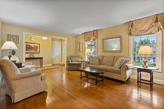 71 Fox Run Dr, Ayer, MA 01432 - living area featuring healthy amount of natural light, wood-type flooring, and baseboards