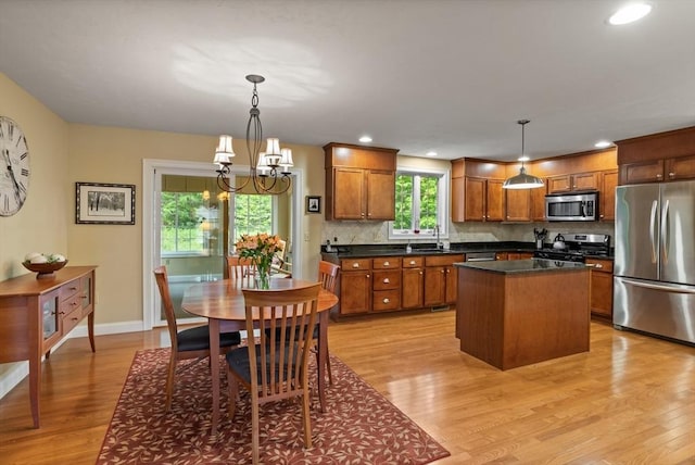71 Fox Run Dr, Ayer, MA 01432 - kitchen featuring appliances with stainless steel finishes, a sink, light wood-style flooring, a chandelier, and recessed lighting