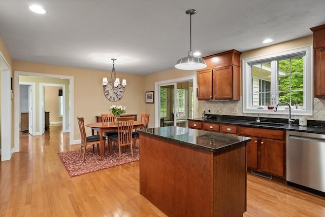 71 Fox Run Dr, Ayer, MA 01432 - kitchen with stainless steel dishwasher, backsplash, a center island, a sink, and light wood-style floors