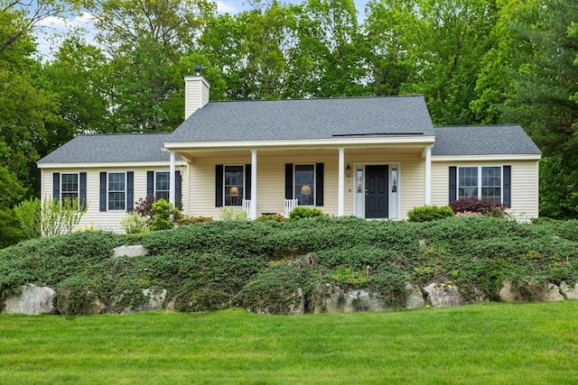 71 Fox Run Dr, Ayer, MA 01432 - view of front of house featuring a chimney, a front yard, covered porch, and roof with shingles