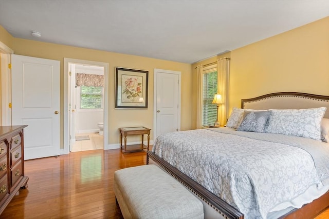 71 Fox Run Dr, Ayer, MA 01432 - bedroom featuring wood finished floors, baseboards, and ensuite bathroom